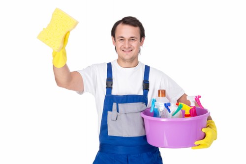Staff assisting a customer at a local Acton laundry service counter